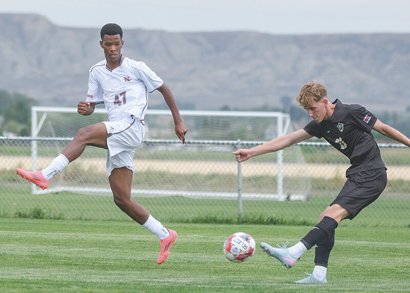 Mateo de Souza (left) jumps up to block a cross by a Rocky Mountain attacker Sunday. De Souza scored the equalizing goal against Providence on Friday as the Trapper men went 1-1-1 in their scrimmages.
Tribune photo by Seth Romsa