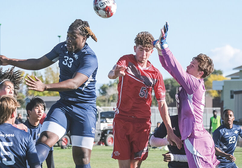 Charles Fox (center) challenges for a header on a corner kick during the Trappers' win against Western Nebraska on Saturday.