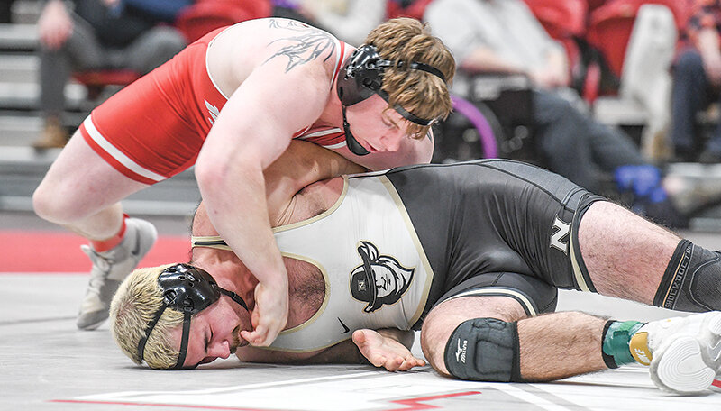 Austin Richens (top) dominated the competition and claimed the heavyweight title at the Plains District Championships on Saturday. Richens is pictured wrestling a Northeastern Junior College wrestler during the Apodaca Duals in January.