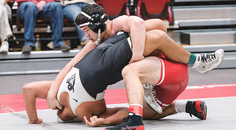Asad Fayzullaev (top) competes during the Apodaca Duals in January. The Trappers head to the NJCAA Plains District Qualifiers on Saturday.
